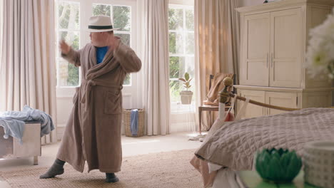 young teenage boy with down syndrome dancing in bedroom feeling happy having fun playful dance celebrating at home on weekend morning