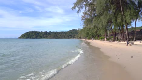 employees sweep the beach for tourists