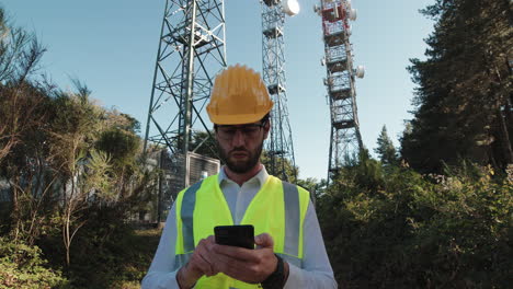 engineer testing reception near antenna