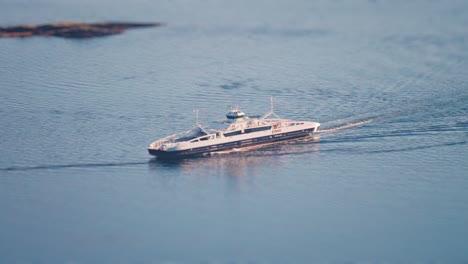 a miniaturized passenger ferry passes between islets near the molde port