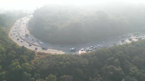 moving vehicles in forest ghat top view mumbai