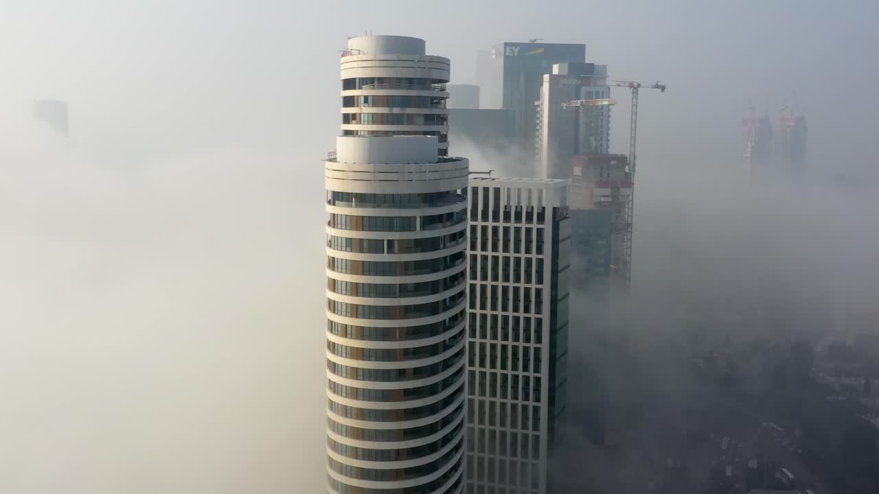 Foggy City Skyline with Modern Buildings under Construction