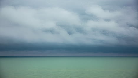 tiempo de tormenta de nubes por encima del agua verde del océano, espacio para el texto en el horizonte