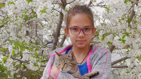 a little girl portrait against the background of a flowering cherry tree