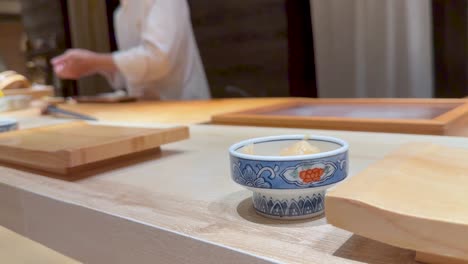 sushi chef preparing food at a restaurant