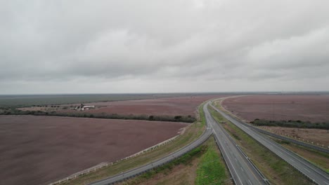 aerial - completely empty highway next to fields, cloudy day, reynosa, tamaulipas, mexico