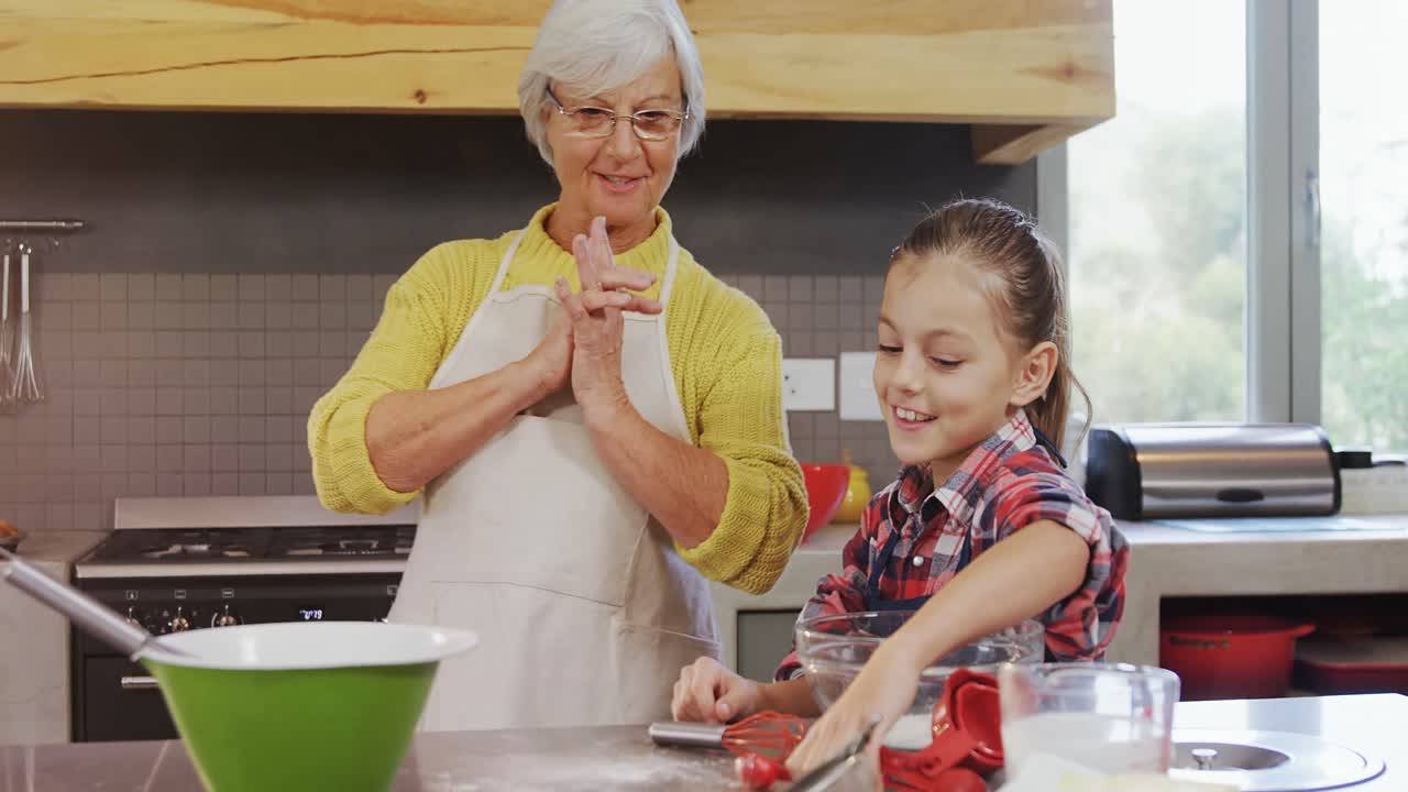 Excited grandmother talking to the girl while preparing cookies 4K 4k