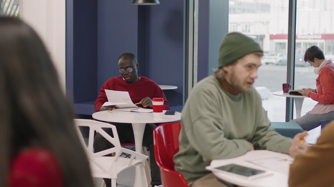 Businesspeople Working in Office Cafeteria or Coworking Space