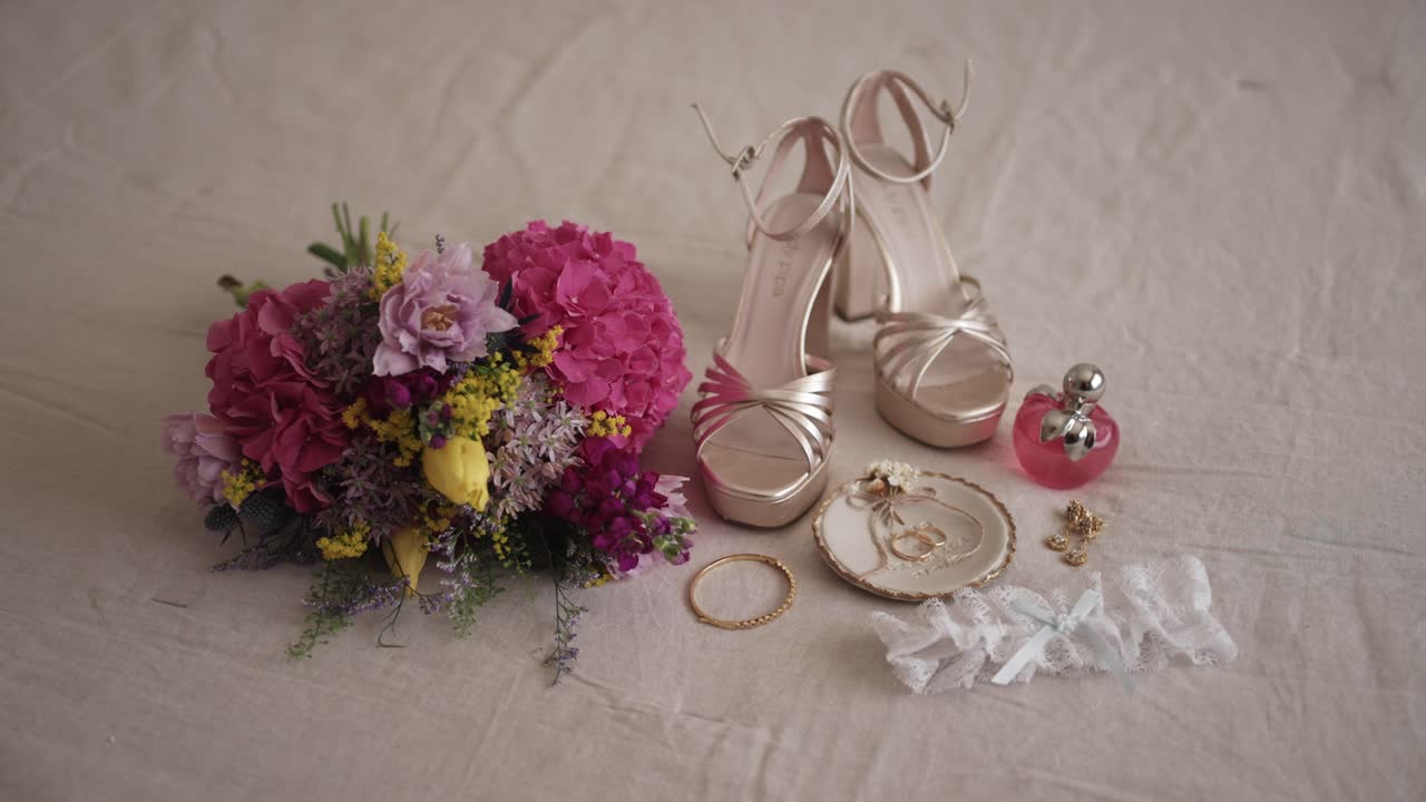Bridal shoes jewelry bouquet and perfume arranged as flat lay before wedding ceremony