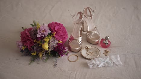 bridal shoes jewelry bouquet and perfume arranged as flat lay before wedding ceremony