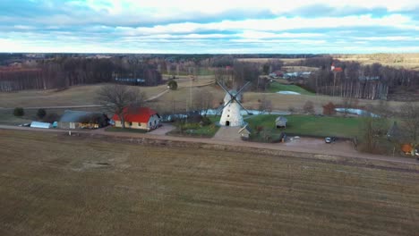 old araisi windmill in latvia aerial shot from above. winter day at sunrise. this is the only windmill in latvia at working order built in 1852. 4k shot