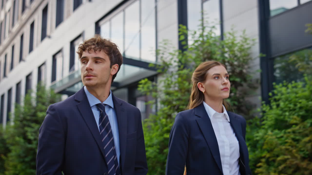 Successful business people strolling in urban street closeup. Serious colleagues