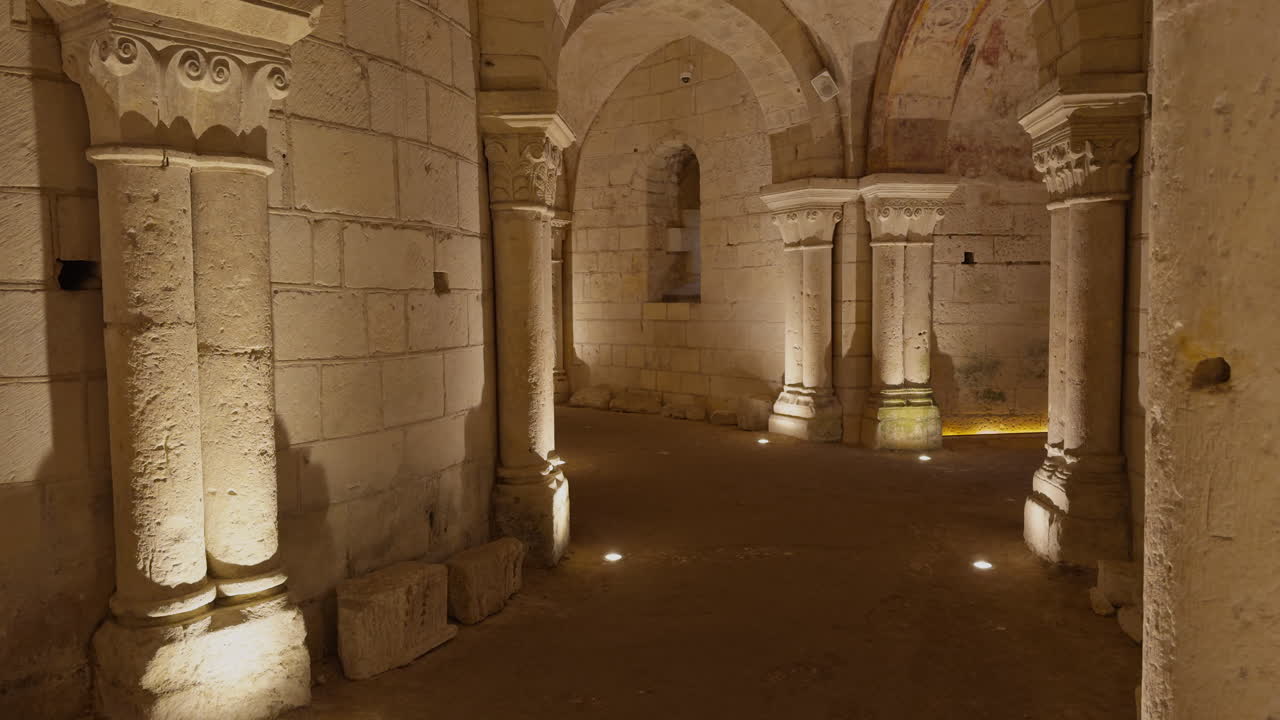 Medieval crypt with stone arches and columns, dimly lit with a historical ambiance