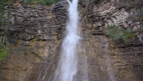 Virginia-Falls-waterfall-in-Glacier-National-Park,-tilt-up-handheld