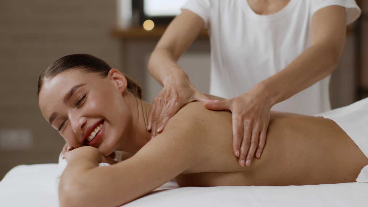 Woman enjoying a relaxing back massage at a spa