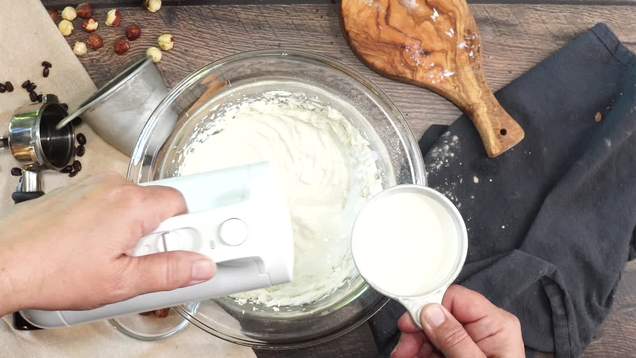 A delicious dessert, Coffee Hazelnut Cream Tart. Made with espresso powder, chocolate crust and loaded with crushed hazelnut. Adding milk to the batter and mixing with an electric mixer