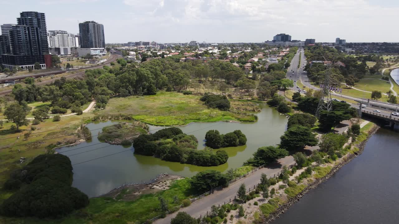 Aerial drone moves backward over nature reserve in Footscray, Melbourne, on a summer day
