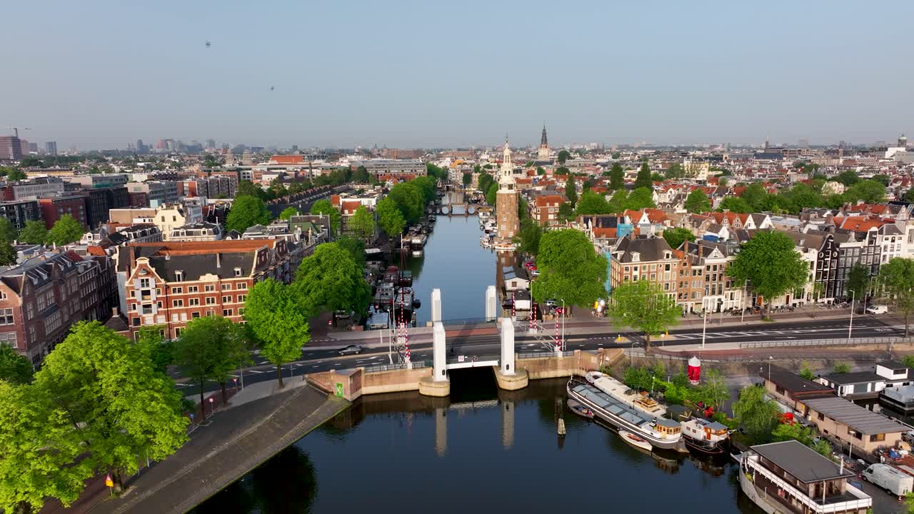 Aerial footage showing boats, green trees, and the historic canal area