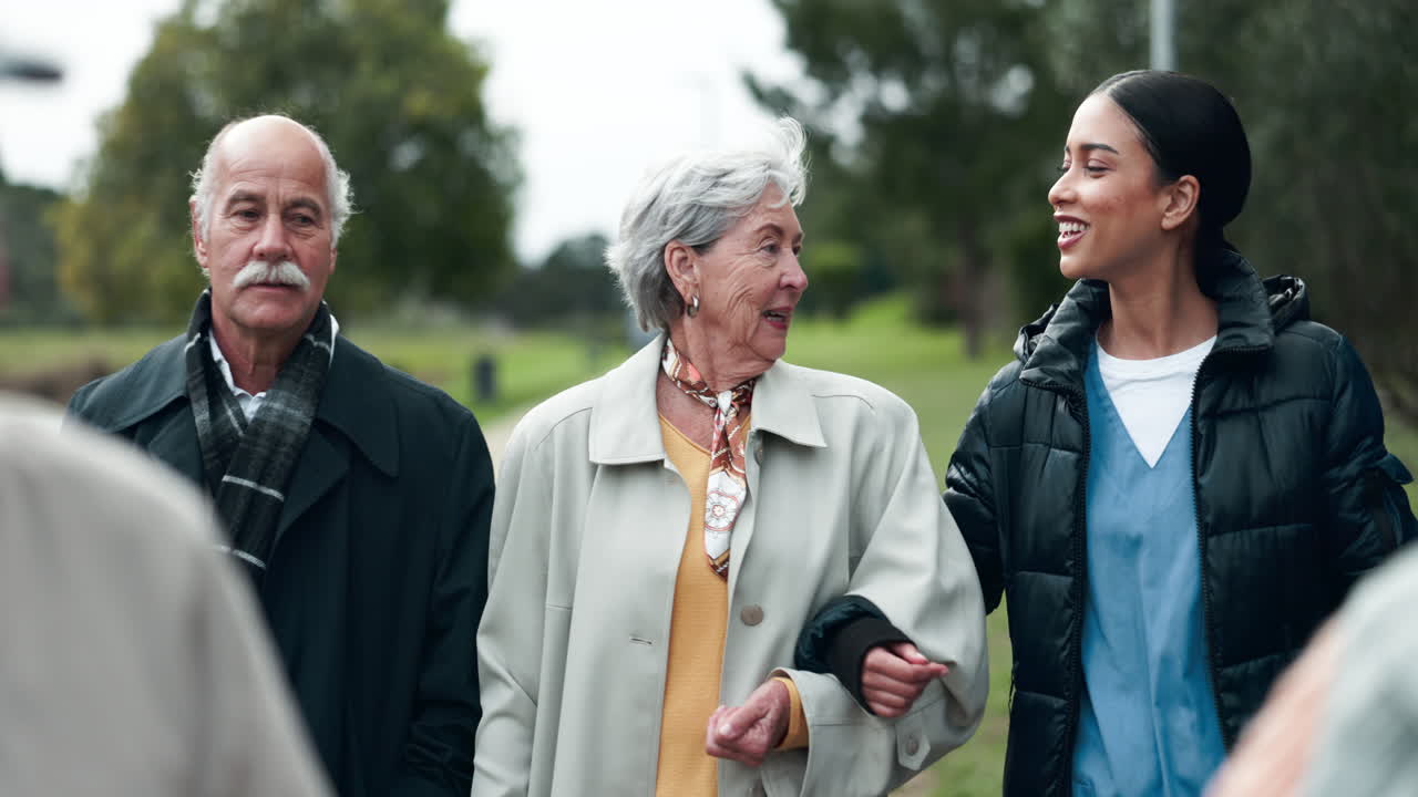 Seniors Enjoying a Walk in the Park with Nurse Assistance