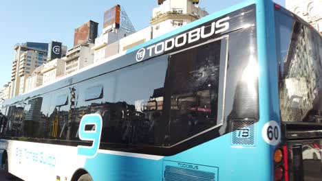 public transport buses traffic at 9 de julio avenue, landmark of buenos aires city at daylight, commercial area