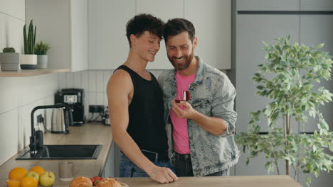 happy gay couple's engagement proposal in the kitchen
