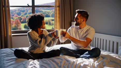couple enjoying coffee in bed