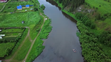 aerial view of a river winding through a countryside village