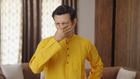 indian man smelling disgusted smell