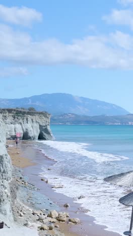 beautiful beach scene with cliffs and mountains