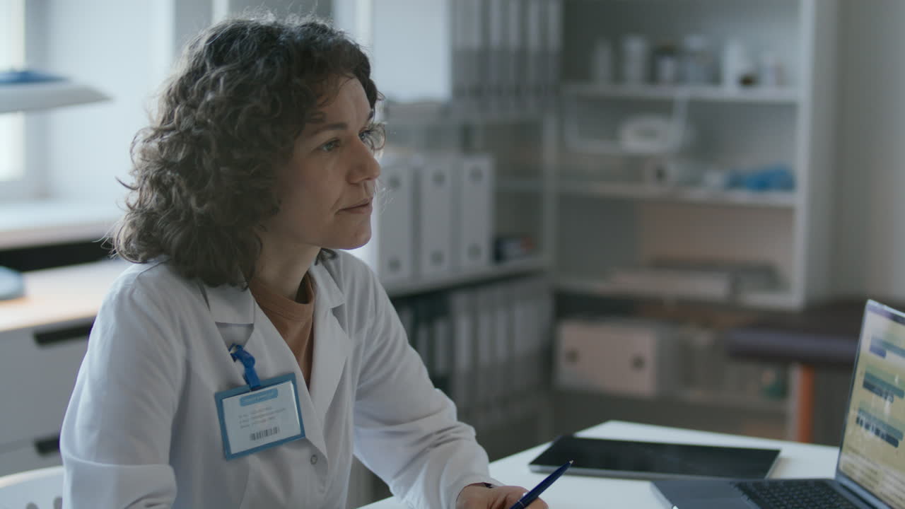 Female Doctor Explaining Treatment Plan to Patient in Medical Office