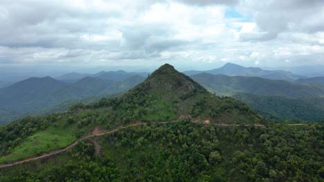 Remote-Mountainous-Road,-Mountain-Top-Spectacular-View-over-Northern-Laos-during-Rainy-Season,-Motorbike-Adventure