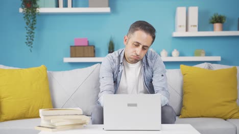 Man-looking-at-laptop-is-unmotivated-and-bored.