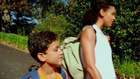 Woman-interacting-with-kids-while-walking-through-park