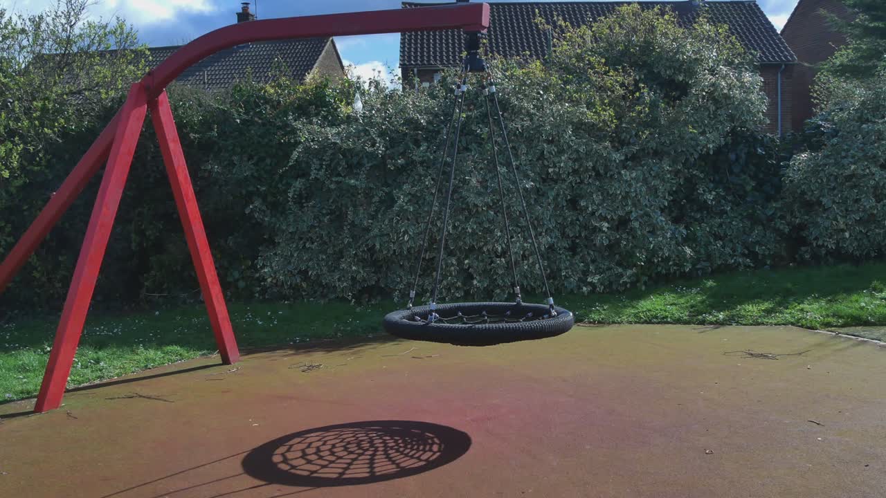 Rope Net Swings In An Empty Playground, UK