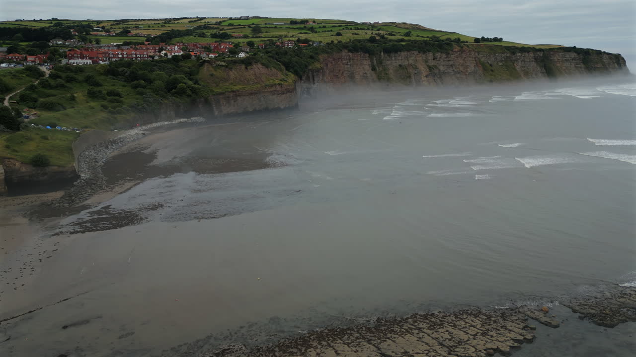 Establishing Aerial Drone Shot of Robin Hood's Bay at Low Tide o Misty Morning
