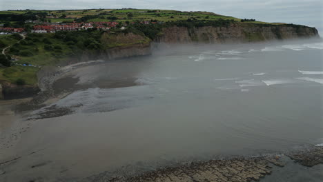 Establishing-Aerial-Drone-Shot-of-Robin-Hood's-Bay-at-Low-Tide-o-Misty-Morning