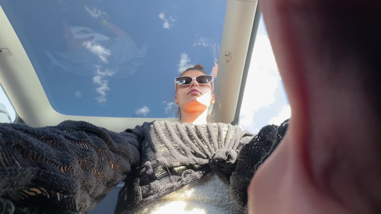 Woman in Car with Sunroof