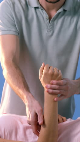 female patient receiving hand massage from physiotherapist