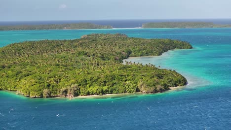 isolated tropical island of vava'u surrounded by blue water in tonga. aerial, wide shot
