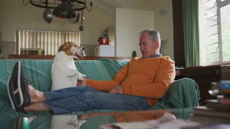 senior man playing with his dog at home