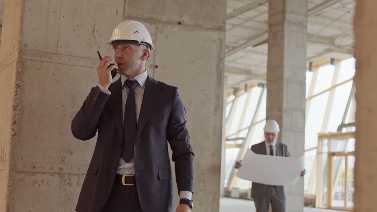 Businessman Using Walkie-Talkie at Construction Site