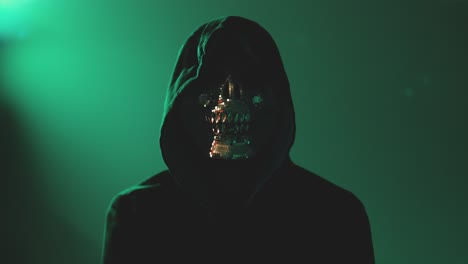 Cybercriminal in Hoodie and Face Mask Staring into Camera with Folded Arms – Depicts Dark Web, Phishing, and Online Data Breach Threats