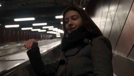 Woman-standing-on-an-escalator-and-talking