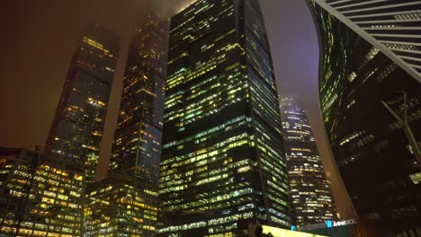 modern futuristic moscow skyscrapers moscow city downtown in fog at night, ominous view of moscow sky towers and business center