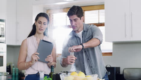 a middle aged couple using a digital tablet