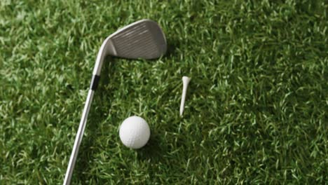 close up of golf club and ball on grass, copy space, slow motion