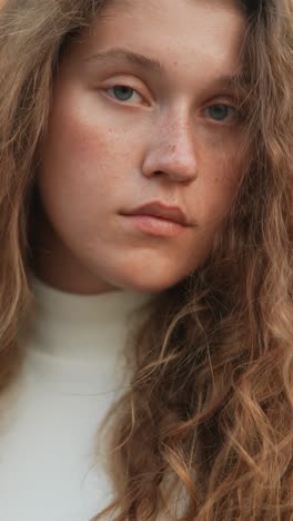 close-up portrait of a young woman with curly hair