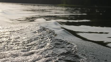 water waves in a lake from a boat, 4k 50 fps can be slow motion