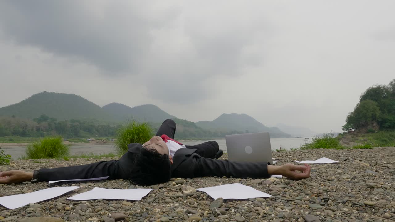 Businessman Relaxing by the River