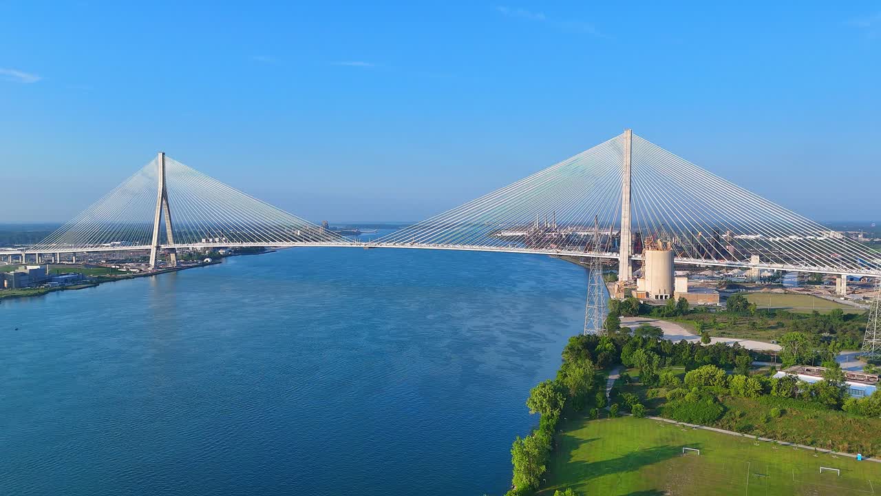Cable-Stayed Gordie Howe International Bridge Over Detroit River on Clear Day, Zug Island in the background